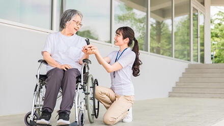 車いすの高齢者と介護職
